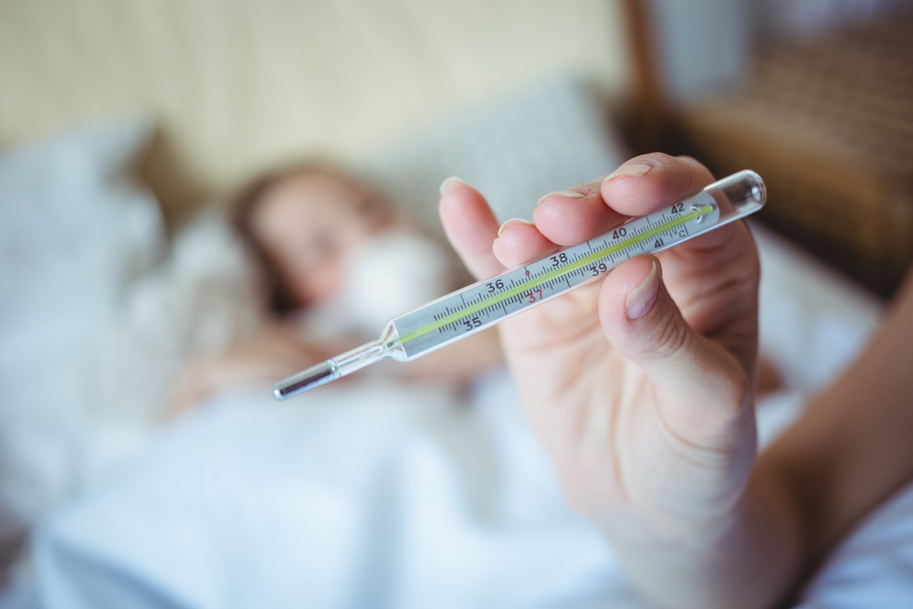 Mother holding a thermometer at home-2